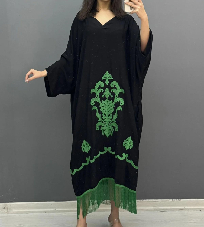 Women's black dress decorated with tassels