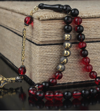 Rosary made of fiery amber stone with name design and silver tassel